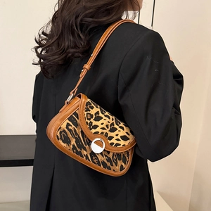 Chic leopard print underarm bag with brown leather trim and silver metal lock closure