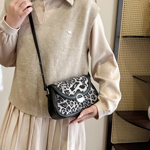 Crossbody leopard print saddle bag with silver buckle and adjustable shoulder strap