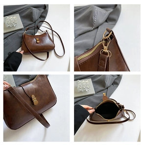 Detail view of vintage dark brown faux leather crescent bag with bronze buckle and strap