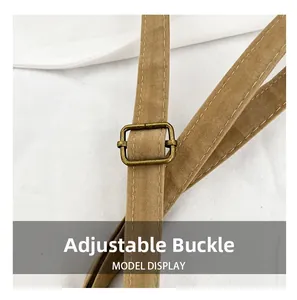 Detail of brown suede shoulder strap with adjustable antique bronze metal buckle