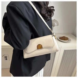 Détail d'un sac baguette crème doté d'une boucle en métal chic avec effet écaille de tortue
