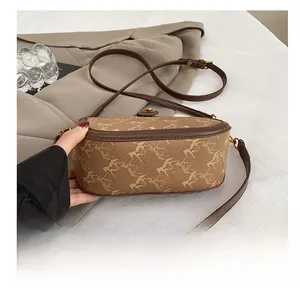 Detail of vintage saddle bag featuring classic horse carriage pattern and gold metal clasp