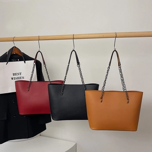 Minimalist large tote bag with metal chain strap in red, black, and caramel brown colors