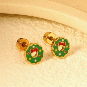 Detailed view of festive green Christmas wreath earrings with red bows and gold accents