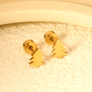 Macro shot of polished gold Christmas tree earrings with metallic finish and push-back studs
