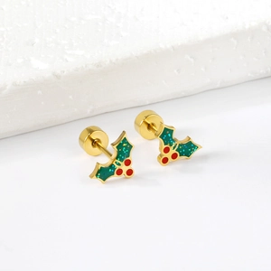 Golden Christmas tree earrings with green holly leaves and red berries on a white stone