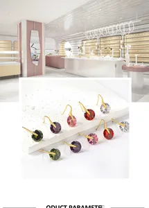 Detail view of multi-color crystal drop earrings set with golden hook fasteners