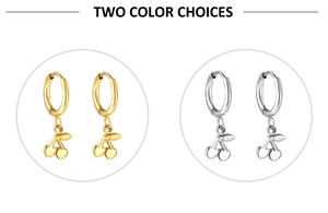 Detail showing cherry pendant hoop earrings in polished gold and silver metal finishes