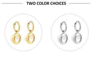 Close-up of gold and silver plated earrings with elegant white shell oval pendants