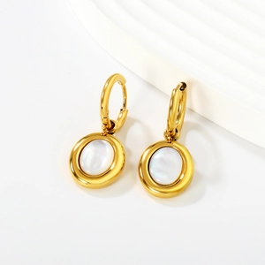 Detail of minimalist gold hoop earrings featuring polished finish and white shell inlay