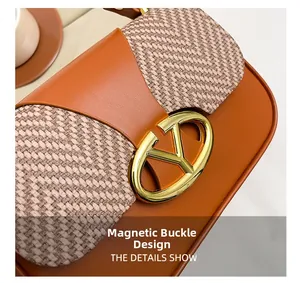 Detail shot of the V-shaped metal logo buckle and magnetic closure on the crossbody bag