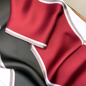 Detailed close-up of premium satin silk scarf showing bicolor fabric with striped edges