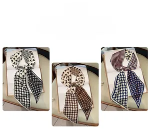 Detailed view of three patterned twilly scarves for handbags and hair styling
