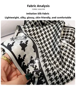 Detailed close-up of soft black and white houndstooth silk-like fabric with satin finish