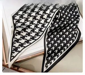 Detail showing the inner seam craftsmanship and houndstooth pattern of the silk scarf