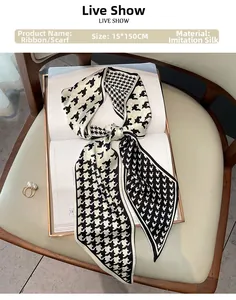 Detail of 15x150cm houndstooth silk scarf elegantly laid on a book for display