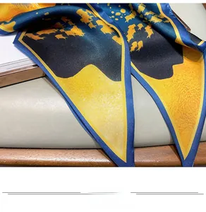 Detail of silk-like scarf featuring blue and yellow oil painting patterns and satin sheen