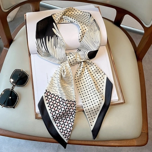 Chic oil painting silk scarf with monochrome feather and polka dot pattern on an open book