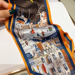 Detailed macro view of an orange silk-like scarf featuring an oil painting town scenery
