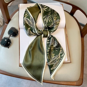 Silk-like oil painting leaf pattern scarf tied on book with vintage green and beige tones
