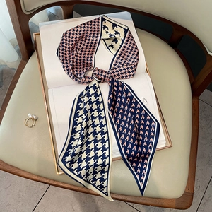 Elegant houndstooth narrow silk scarf for women styled on a vintage chair