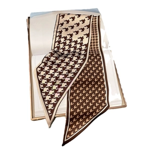 Classic brown houndstooth silk scarf for women displayed on a white book prop