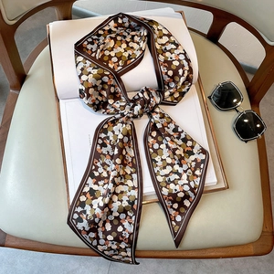 Close-up of silk scarf with retro abstract polka dots and fine white contrast stitching