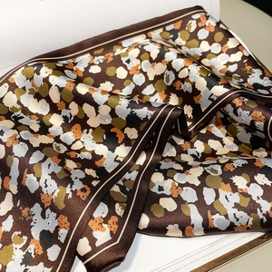 Detail of oil painting print silk scarf with brown border and vibrant color blocks
