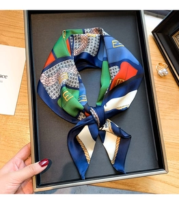 Détail macro d'un foulard en soie avec blocs de couleurs géométriques et logo