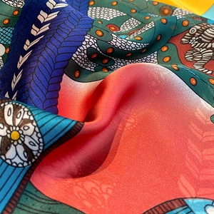 Macro shot of colorful floral print silk scarf showing smooth texture and drapes