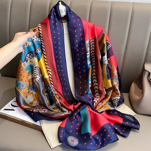 Vibrant retro silk scarf with geometric prints and human figures draped on a classic sofa