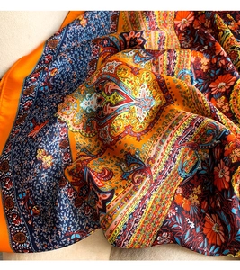 Detail showing the paisley and floral print on smooth silk-like fabric with elegant folds