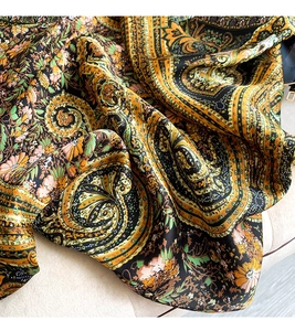 Close-up of vintage paisley floral print silk scarf with luxury satin fabric luster