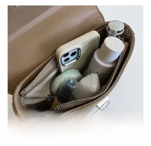 Interior view showing the storage capacity of the brown lychee grain leather handbag