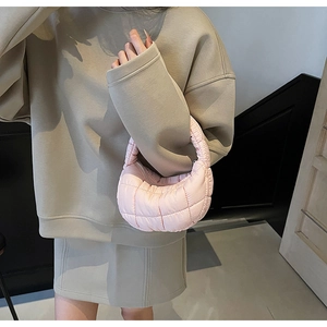 Detailed texture of pink quilted cloud bag featuring soft nylon fabric and puffy finish