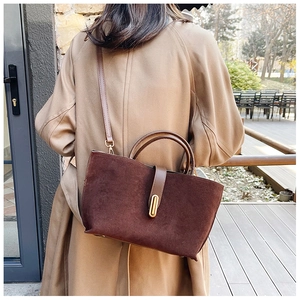 Deep brown frosted leather tote bag with gold oval buckle and crossbody strap detail