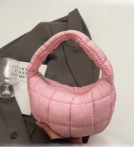 Detailed view of pink quilted cloud bag with plush nylon texture and zipper closure