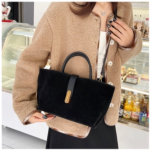 Detail of vintage matte tote bag showing golden metal buckle and leather handle