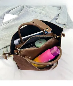 Top view of spacious interior storage with organizer pouch in vintage brown tote bag