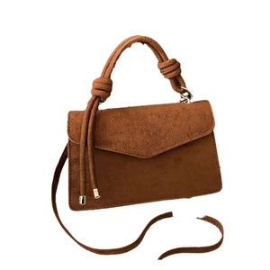 Minimalist matte dark brown crossbody handbag with elegant knot details and gold tips