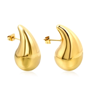 Polished gold teardrop earrings with butterfly backs shown on white surface