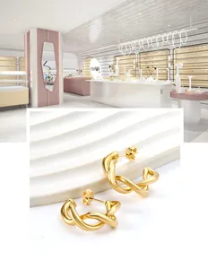 Vue détaillée des boucles d'oreilles créoles torsadées plaquées or 18 carats avec fermoir