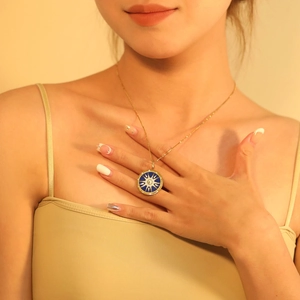 Gros plan d'un collier doré avec pendentif tarot bleu sur le cou d'une femme