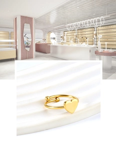 Detailed shot of golden minimalist open heart ring with beads on a white wavy display stand