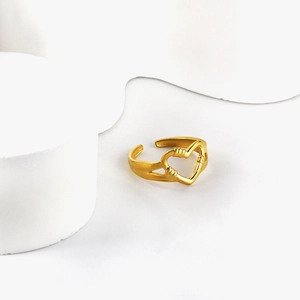 Matte gold hollow heart open ring with minimalist adjustable band on white geometric block
