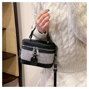 Detail of vintage crossbody box bag with mixed leather and fabric textures
