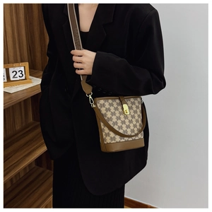 Detailed view of monogram bucket bag with adjustable wide branded woven shoulder strap