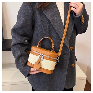 Detail of vintage patchwork mini box bag with brown leather and beige canvas texture