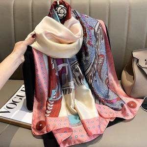 Pink and beige horse motif silk scarf with camellia brooch on black outfit