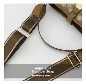 Close-up of adjustable jacquard and leather straps on brown monogrammed bucket bag
